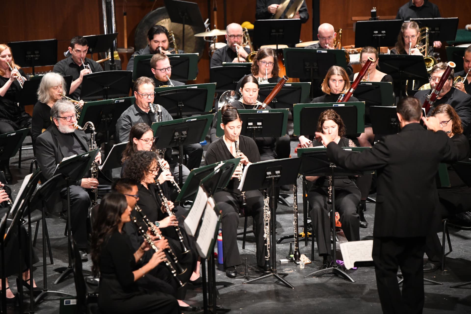 The conductor cueing the woodwind section